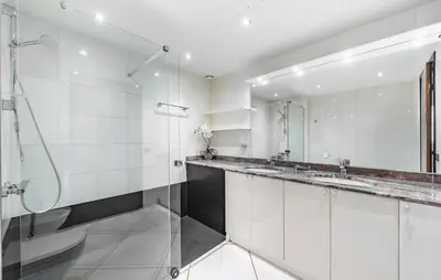 a bathroom with two sinks and a glass shower at 2 Bedroom Cozy Apartment In Cannes in Cannes