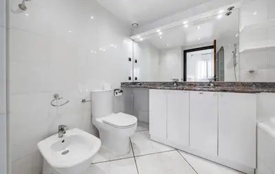 a white bathroom with a toilet and a sink at 2 Bedroom Cozy Apartment In Cannes in Cannes