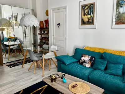 a living room with a blue couch and a table at Cannes Sweet Cannes in Cannes