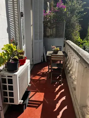 a patio with a table and chairs on a balcony at Cannes Sweet Cannes in Cannes
