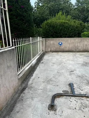 a fence with a hose on the ground next to at Cannes Sweet Cannes in Cannes