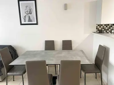 a dining room with a table and chairs at Modern one bedroom apartment in Cannes in Cannes
