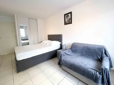a bedroom with a bed and a chair in it at Modern one bedroom apartment in Cannes in Cannes