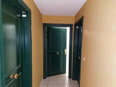 a hallway with two green doors and a tile floor at Modern one bedroom apartment in Cannes in Cannes