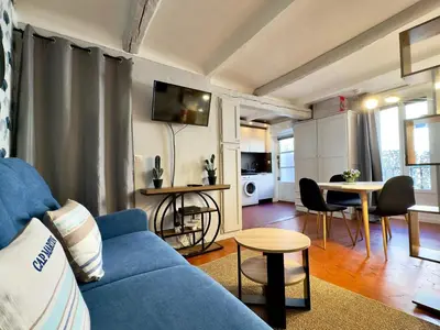 a blue couch in a living room with a table at La Castre By SCLS Locations in Cannes