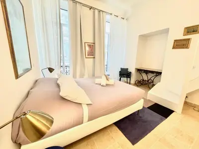 a large bed in a room with a large window at Marina Luxury 3 bedroom by Welcome to Cannes in Cannes
