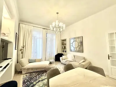 a living room with white furniture and a chandelier at Marina Luxury 3 bedroom by Welcome to Cannes in Cannes