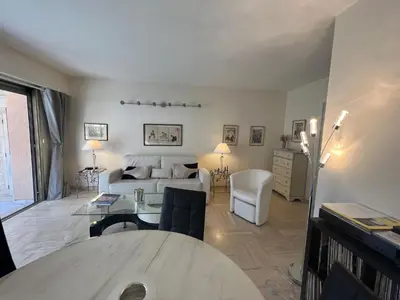 a living room with a couch and a table at Alexandra apartment by Welcome to Cannes in Cannes