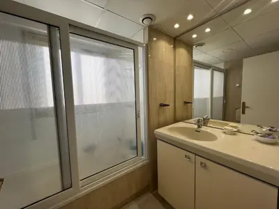 a bathroom with a sink and a glass shower at Alexandra apartment by Welcome to Cannes in Cannes