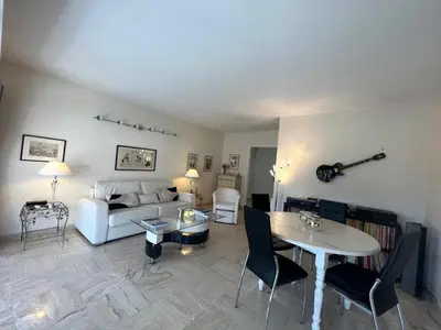 a living room with a white couch and a table at Alexandra apartment by Welcome to Cannes in Cannes