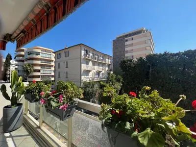 a balcony with potted plants and buildings at Alexandra apartment by Welcome to Cannes in Cannes