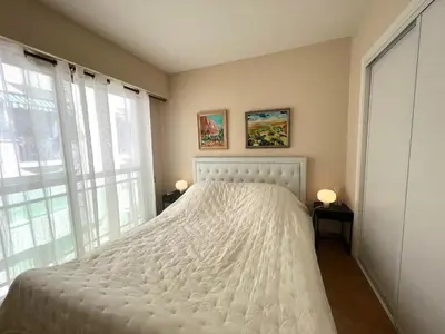 a bedroom with a white bed and a window at Alexandra apartment by Welcome to Cannes in Cannes