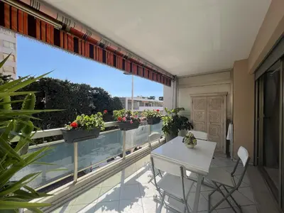 a balcony with a table and some plants on it at Alexandra apartment by Welcome to Cannes in Cannes