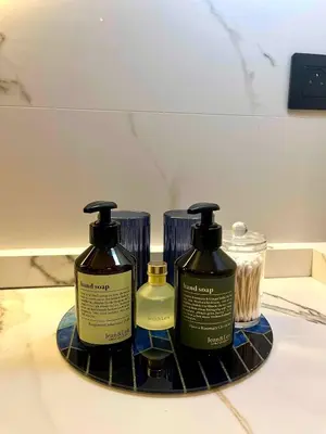 two bottles ofodorizers on a tray on a bathroom counter at Parc Montfleury in Cannes
