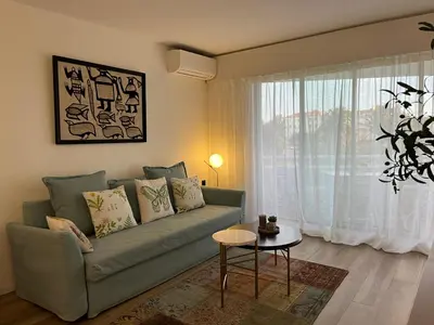 a living room with a green couch and a table at Parc Montfleury in Cannes