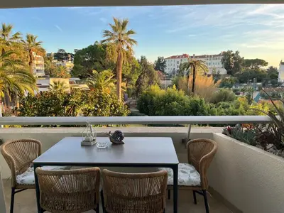 a table and chairs on a balcony with a view at Parc Montfleury in Cannes