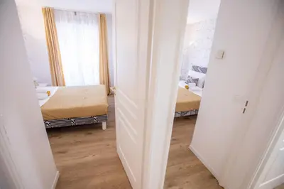 a small room with two beds and a mirror at Luxueux 3p. Art Deco + Parking in Cannes