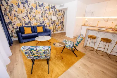 a living room with a blue couch and two chairs at Luxueux 3p. Art Deco + Parking in Cannes