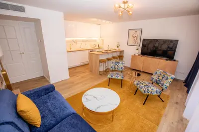 a living room with a blue couch and chairs at Luxueux 3p. Art Deco + Parking in Cannes