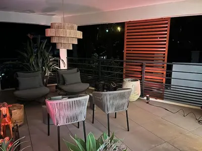a patio with chairs and a pendant light at Horizon Bay - Pool - Fitness Room - Terrace in Cannes