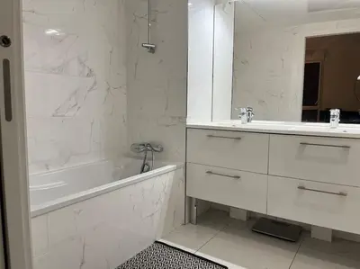 a white bathroom with a tub and a sink at Horizon Bay - Pool - Fitness Room - Terrace in Cannes