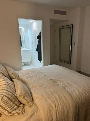 a bed with two pillows and a mirror in a bedroom at Horizon Bay - Pool - Fitness Room - Terrace in Cannes