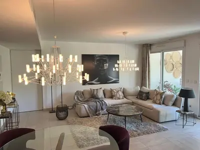 a living room with a couch and a table at Horizon Bay - Pool - Fitness Room - Terrace in Cannes