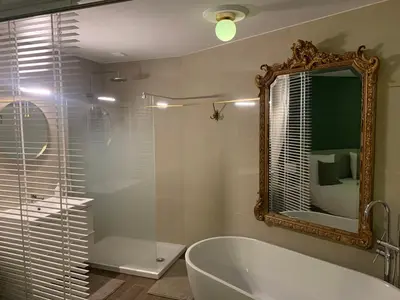 a hotel room with a bed and a couch at Villa les fougeres suite festival jardin garage in Cannes