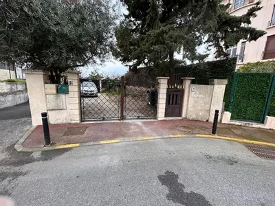 a gate in front of a house with a driveway at CANNES RIVAGE bord de mer in Cannes