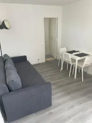 a living room with a couch and a table at Magnifique appartement in Cannes