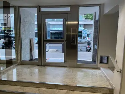 an entrance to a building with sliding glass doors at Magnifique appartement in Cannes