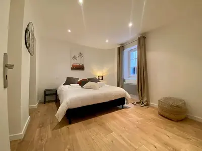 a bedroom with a bed and a large window at Appartement Centre ville, Cannes le Suquet in Cannes