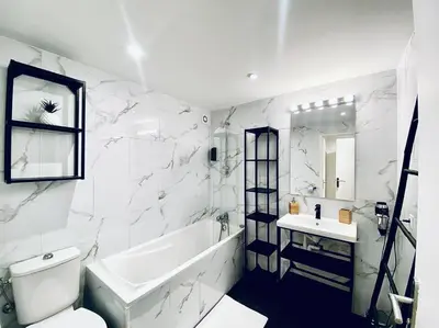 a white bathroom with a tub and a sink at Appartement Centre ville, Cannes le Suquet in Cannes