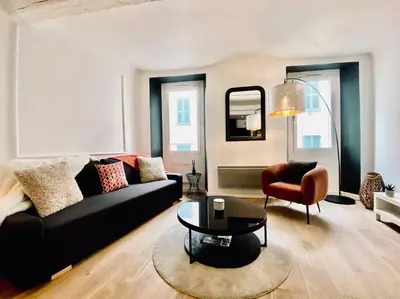 a living room with a couch and a table and a chair at Appartement Centre ville, Cannes le Suquet in Cannes