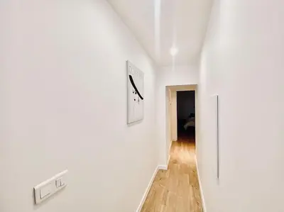 a hallway with white walls and wooden floors at Appartement Centre ville, Cannes le Suquet in Cannes