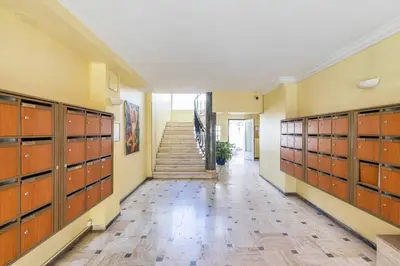 a hallway with wooden lockers in a building with a staircase at Appartemet a Cannes/Plage/Centre in Cannes