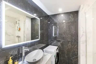 a bathroom with a toilet and a sink and a mirror at Appartemet a Cannes/Plage/Centre in Cannes