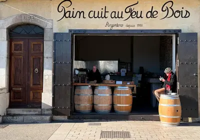 a man sitting in the entrance of a store with barrels at Villa Quartier Oxford garden & pool in Cannes AC in Cannes