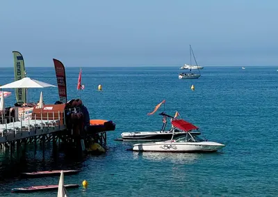 two boats are docked at a dock in the water at Villa Quartier Oxford garden & pool in Cannes AC in Cannes