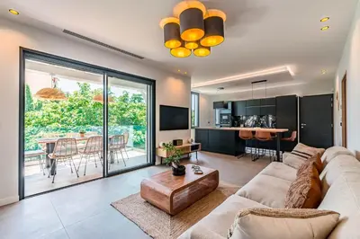 a living room with a couch and a table at Villa Quartier Oxford garden & pool in Cannes AC in Cannes