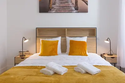 a bedroom with a large bed with two towels on it at Rue De Bone by Halldis in Cannes