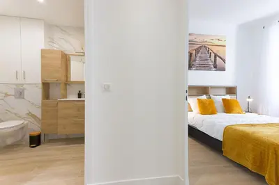 a bedroom with a bed and a bathroom at Rue De Bone by Halldis in Cannes