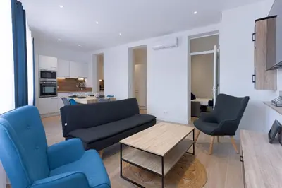 a living room with a couch and two chairs and a table at Rue De Bone by Halldis in Cannes
