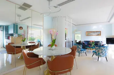 a living room with two tables and chairs at CROISETTE AZUR ONE BEDROOM APARTMENT WITH TERRACE in Cannes
