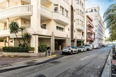 a street with cars parked in front of a building at CROISETTE AZUR ONE BEDROOM APARTMENT WITH TERRACE in Cannes